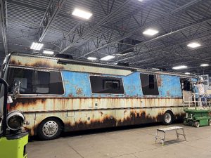 Image of a very old Fleetwood RV being worked on