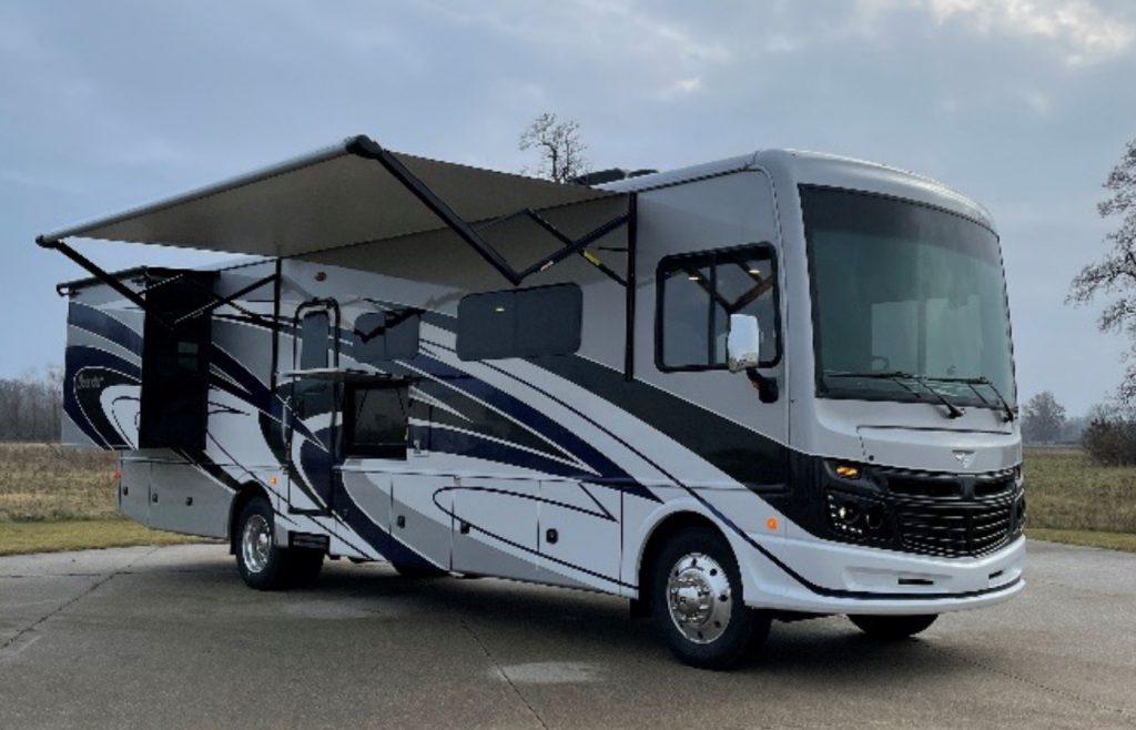 Fleetwood RV by an open space with grass and trees