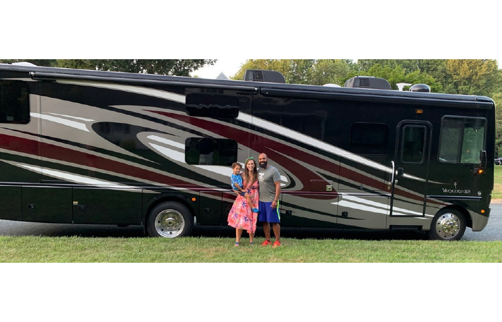 Family in front of a Holiday Rambler RV
