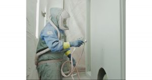 Image of a person painting a Wheeled Coach ambulance