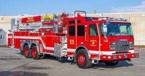 E-One Red Fire Truck Image in front of a building.