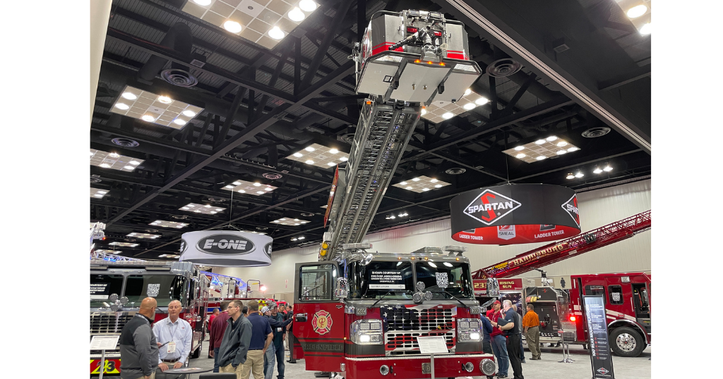 Firefighter trade show floor with aerial ladder up