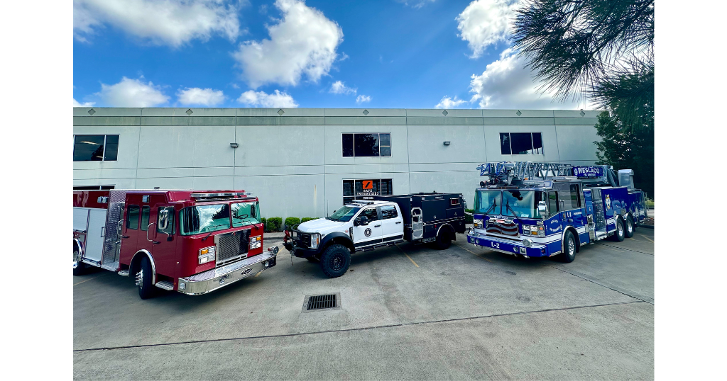 Building with three emergency vehicles in front of it